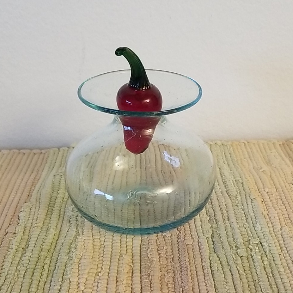 Some glass bottle with chile pepper stopper.
